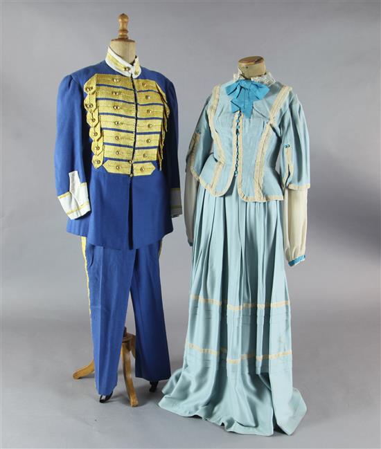 Rigoletto: A rail with a pale blue skirt and jacket, a quantity of royal blue gold braided jackets and trousers,